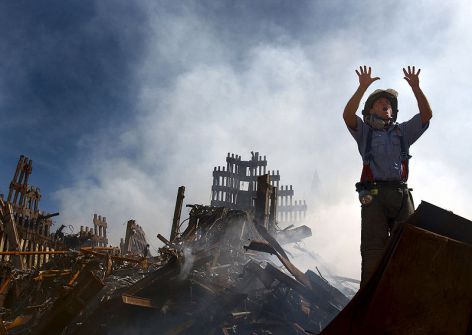 Looking back on 9/11: A New York City fireman calls for 10 more rescue workers to make their way into the rubble of the World Trade Center (U.S. Navy photo; Wikimedia Commons).