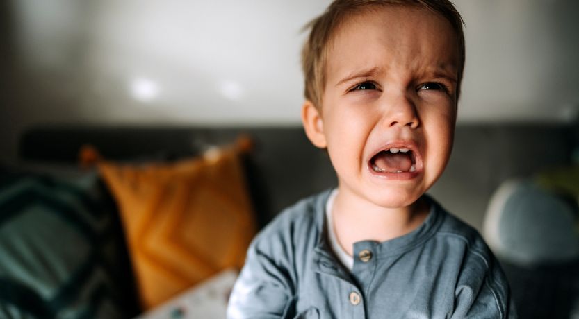 Photo of an upset screaming child to illustrate the article Are Humans Inherently Good or Evil?