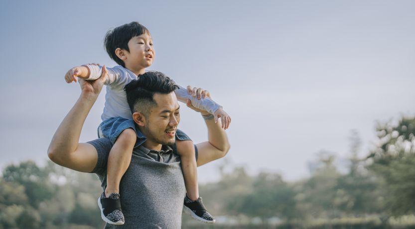 Photo of a father holding his son on his shoulders to illustrate the article Biblical Fatherhood