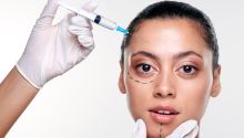 Photo of a young woman with face marked as if for cosmetic surgery, to illustrate the article 