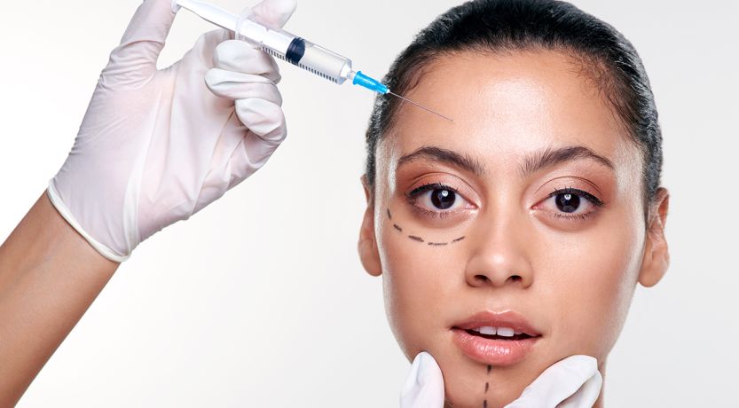 Photo of a young woman with face marked as if for cosmetic surgery, to illustrate the article
