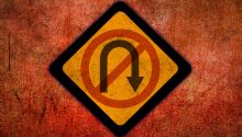 Graphic of a stylized no U-turn sign to illustrate the article Are We at the Point of No Return?