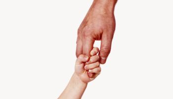Photo of a father's hand holding a small child's hand to illustrate the article Fumbling Through Parenthood: What Becoming a Dad Has Taught Me About God