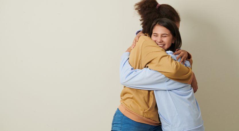Photo of two friends hugging, to illustrate the article 
