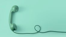 Graphic of a green, old-fashioned corded land-line phone, to illustrate the article 
