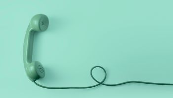 Graphic of a green, old-fashioned corded land-line phone, to illustrate the article 