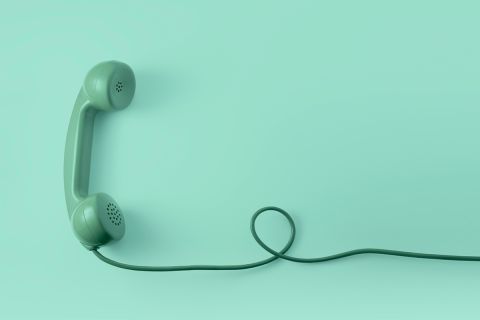 Graphic of a green, old-fashioned corded land-line phone, to illustrate the article 