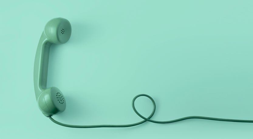 Graphic of a green, old-fashioned corded land-line phone, to illustrate the article 