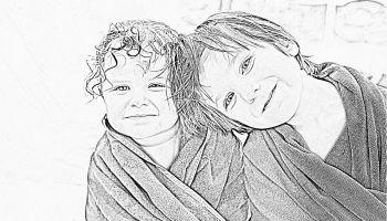 Black and white photo of two little girls with wet hair wrapped in towels to illustrate the article 