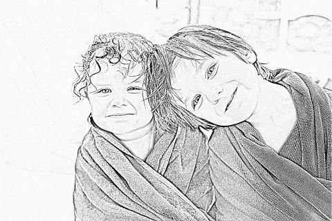 Black and white photo of two little girls with wet hair wrapped in towels to illustrate the article 