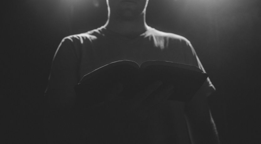 Silhouette of a man holding an open Bible to illustrate the article Faith of the Apostle Thomas: Don’t Call Him Doubting Thomas