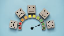 Graphic of a meter going from frowny faces to smiley faces to illustrate the article How Do You Measure Happiness?