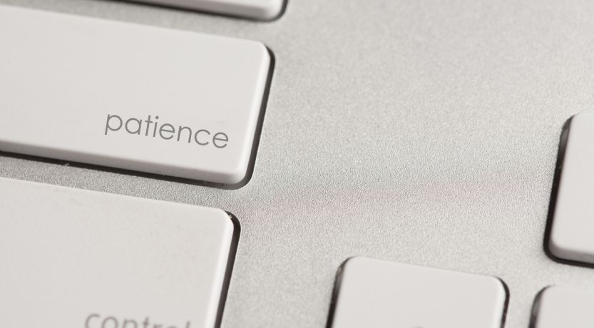 Photo of a keyboard with the word patience on one of the keys to illustrate the article How to Have More Patience.