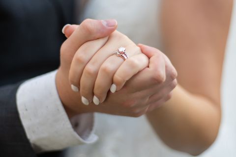 Photo of the hands of the couple at their wedding, to illustrate the article Lessons From 204 Years of Marriage.