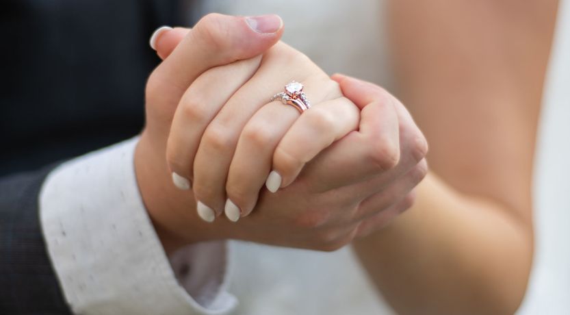 Photo of the hands of the couple at their wedding, to illustrate the article Lessons From 204 Years of Marriage.