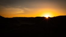 Photo of sun over Sinai mountains to illustrate the article No One Can See God and Live.