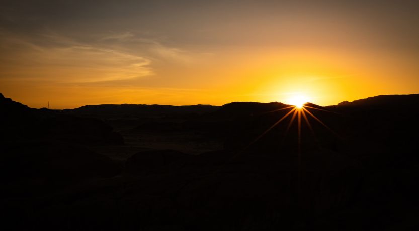 Photo of sun over Sinai mountains to illustrate the article No One Can See God and Live.