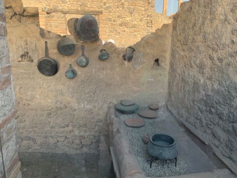 <p>Cooking area with pans from ancient Pompeii.</p>