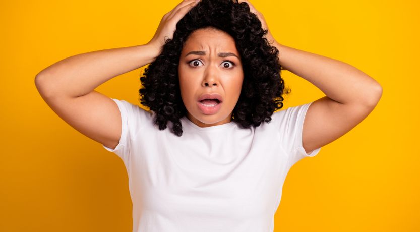 Photo of a girl with her hands on her head looking shocked to illustrate the article Shocking Statements in the Bible: How Can We Understand Them?