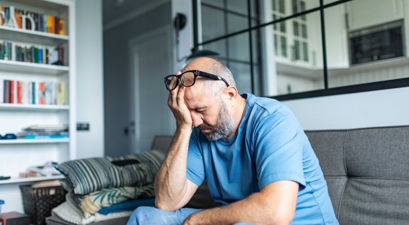 Photo of a man sitting with his face in his hand to illustrate the article 