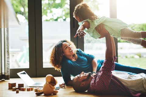 Photo of parents playing with child to illustrate the article The Family That Plays Together