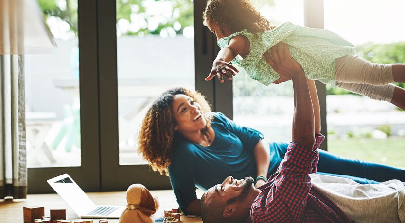Photo of parents playing with child to illustrate the article The Family That Plays Together