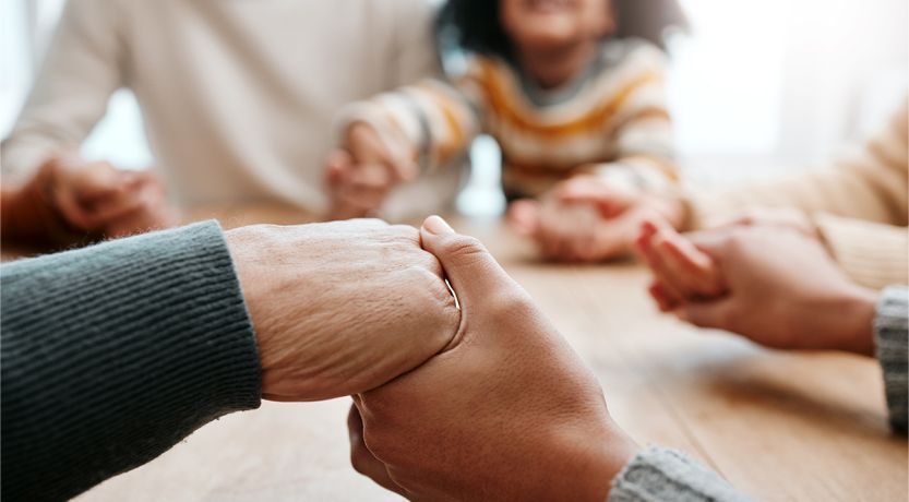 Photo of family holding hands to illustrate the article The Family That Prays Together