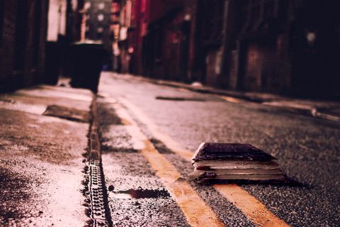Photo of a Bible on a city street at night, to illustrate the article Truth Is Fallen in the Street