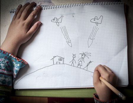 <p>A child’s drawing of a scene of war.</p>