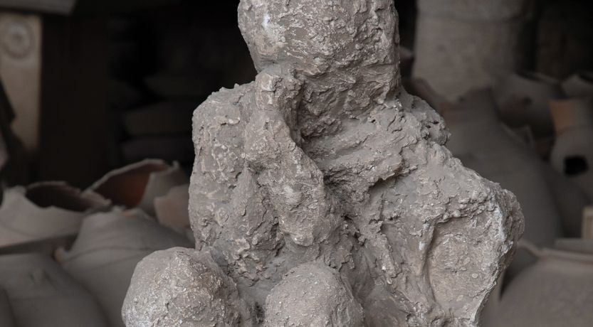 A photo of a cast made from a body found buried in Pompeii, to illustrate the article The Fate of Those Who Died in Pompeii