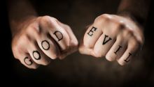 What Is Human Nature? (photo of fists with Good and Evil written on them)