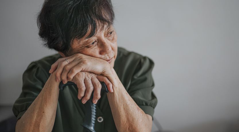 Woman leaning on a cane and wondering, Why Am I Unhappy?