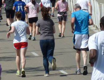 <p>Mike's daughters, Erica and Heather, join him to<br />
finish the last stretch of the marathon.</p>