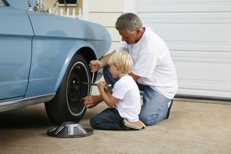 Grandfather and Grandson Changing Tire