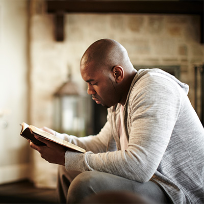 Man sitting down reading the Bible