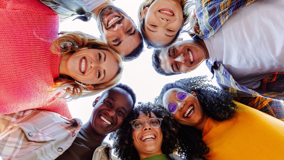 Photo looking up at a circle of friendly faces to illustrate the article Become All Things to All Men