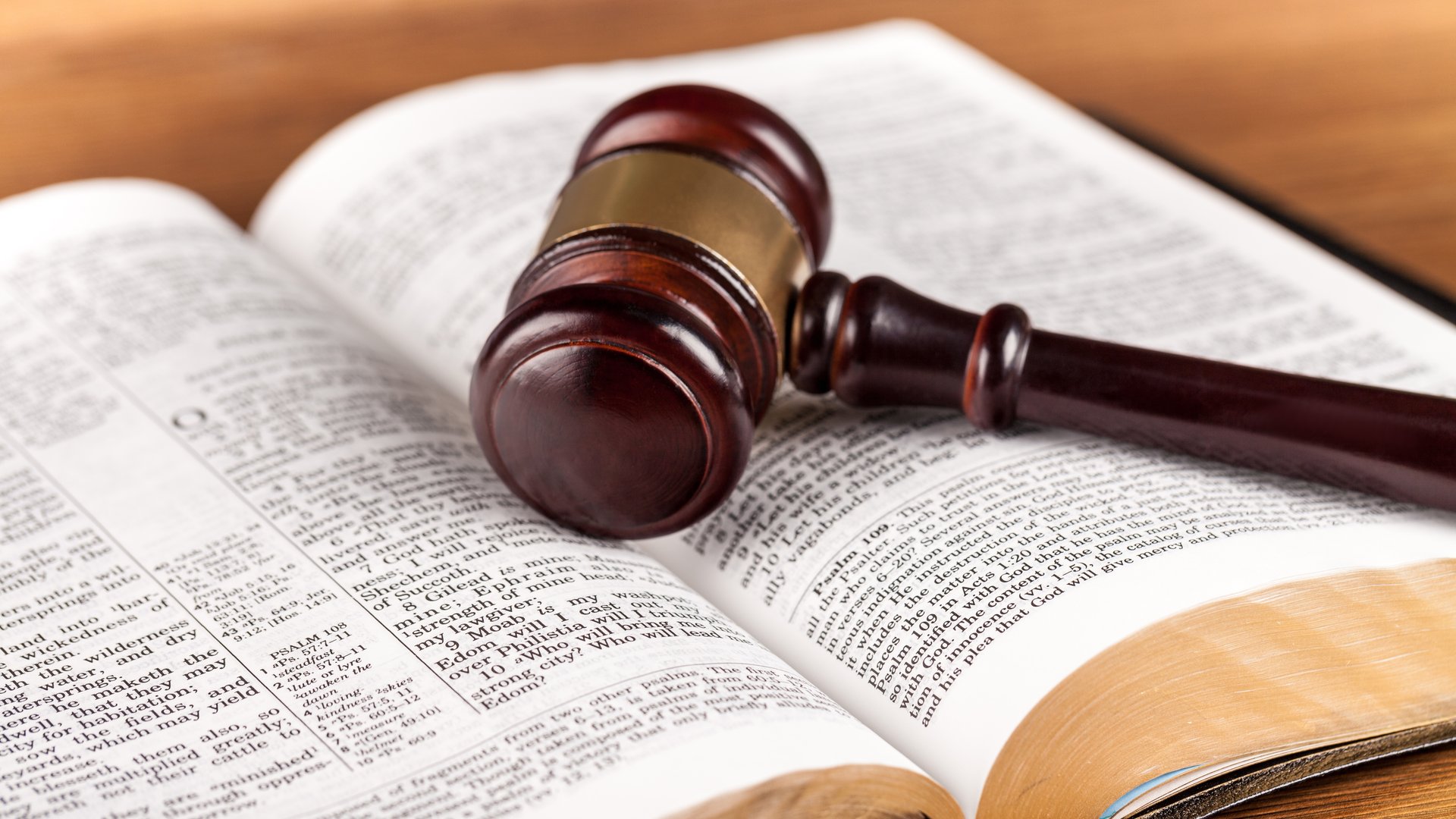 Photo of a Bible with a judge's gavel on top to illustrate the article Are There Really 613 Laws?