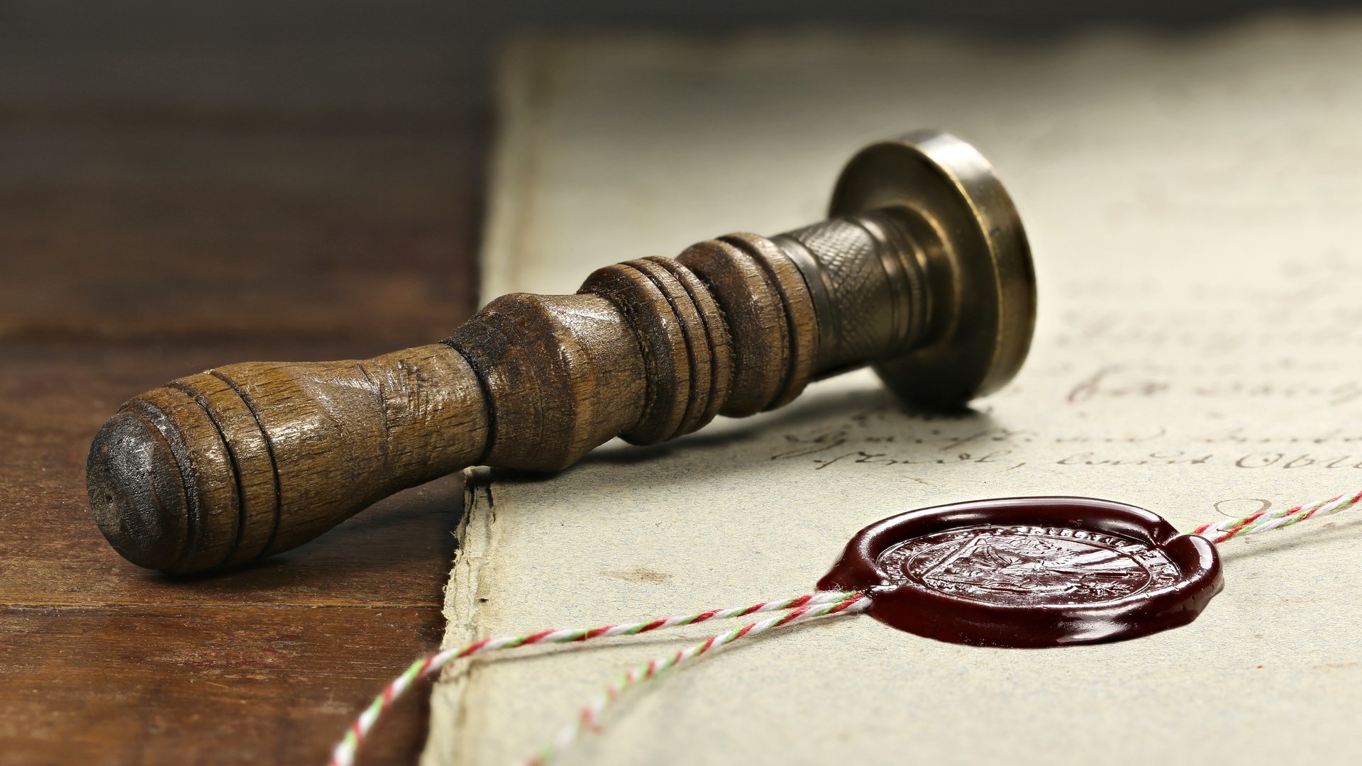 Photo of a seal laying beside a wax seal on a document to illustrate the article Sealed by God
