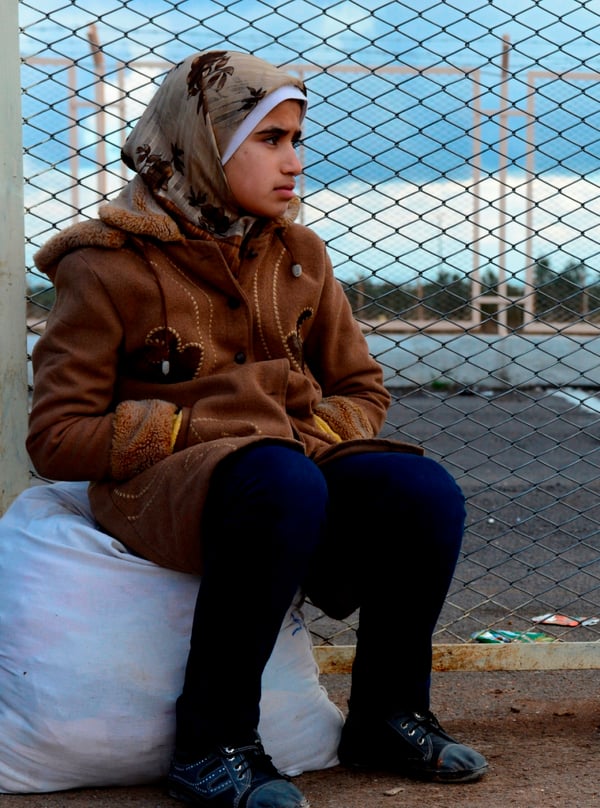 <p>Syrian woman awaits transport to a refugee camp in Turkey.</p>