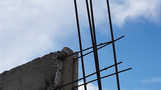 A crumbling foundation and reinforcing rods.
